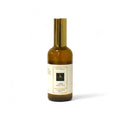 Amber Radiance room spray bottle with gold cap on a white background
