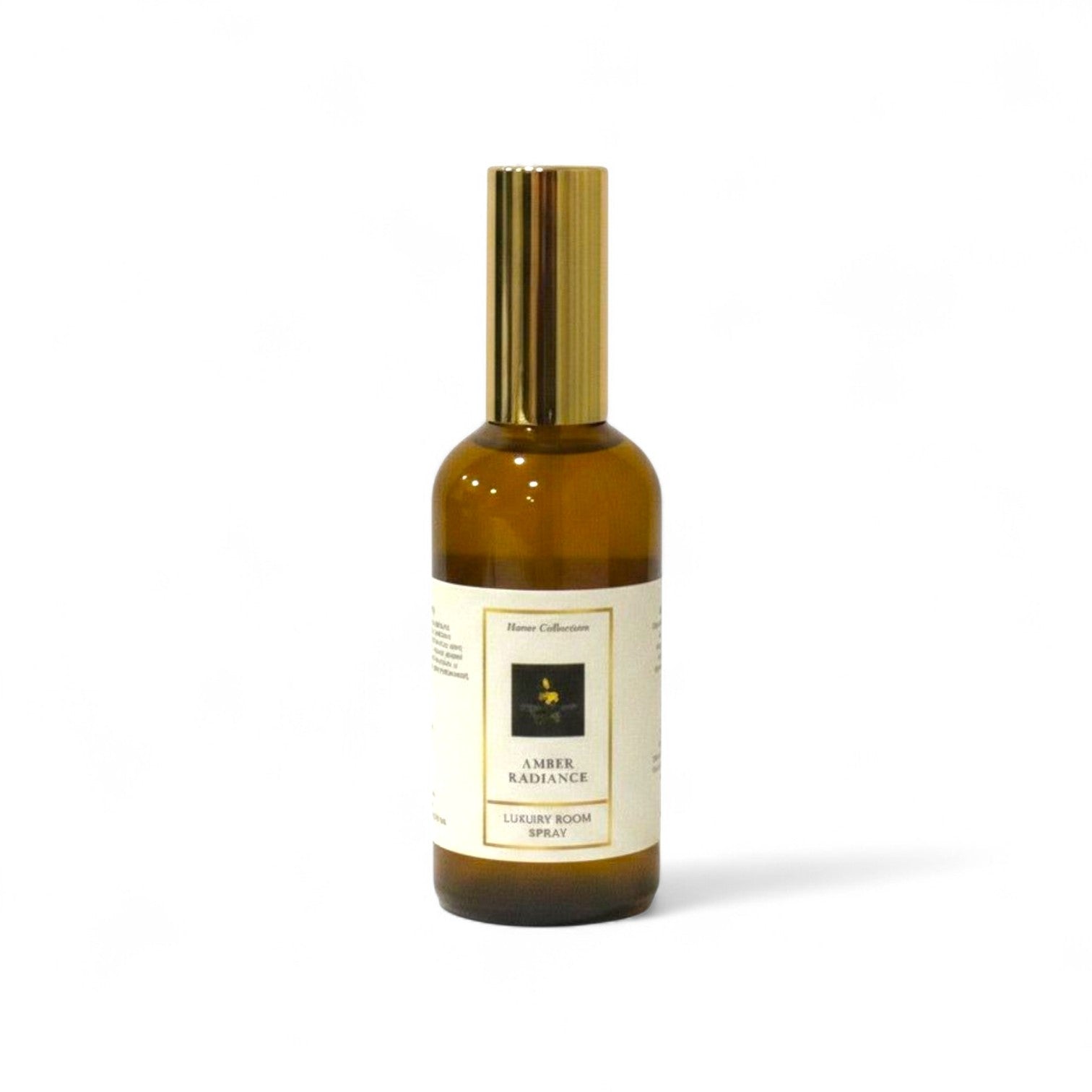 Amber Radiance room spray bottle with gold cap on a white background