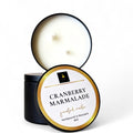 Cranberry Marmalade scented candle in a tin with a white label on a white background