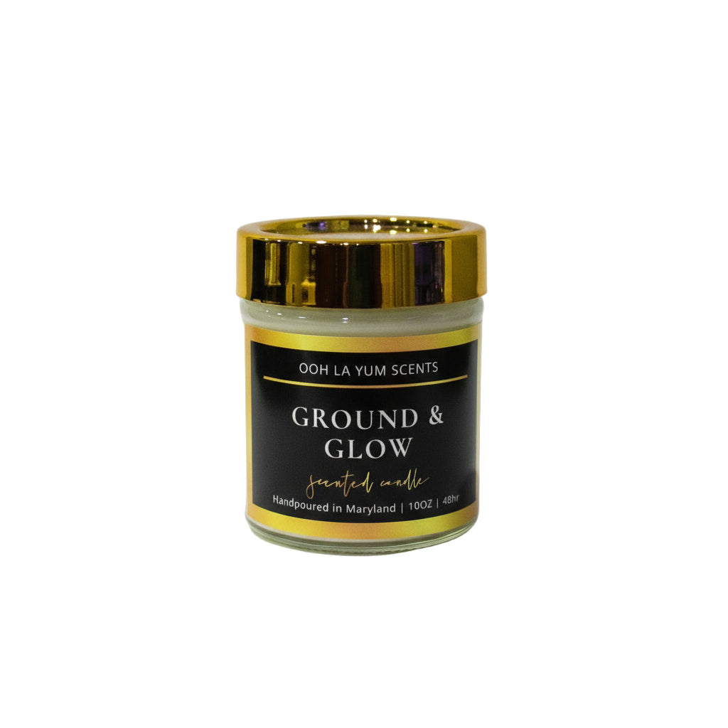 Candle jar labeled 'Ground & Glow' by Ooh La Yum Scents on a white background