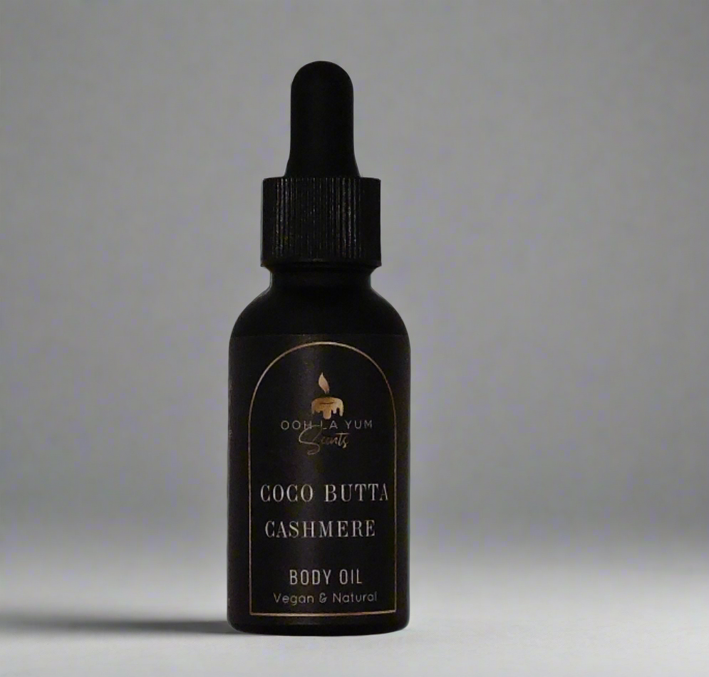 Coco Butta Cashmere body oil in a black glass dropper bottle.