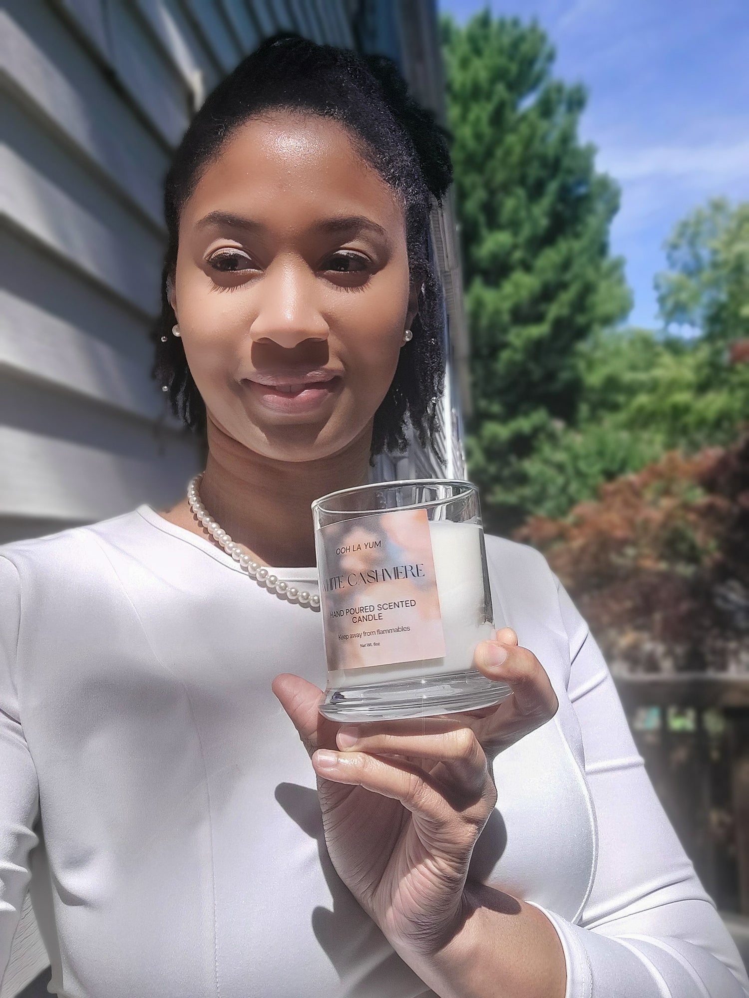 A picture of a woman holding a candle.