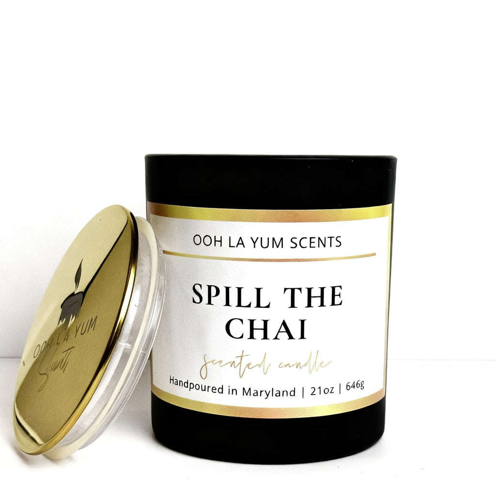 Candle with 'Ooh La Yum Scents' branding and 'Spill the Chai' label on a white background