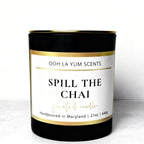 Candle with 'Spill the Chai' label on a white background