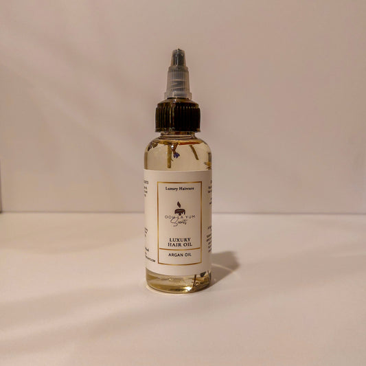 Bottle of luxury hair oil with a label on a beige background