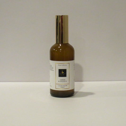 Bottle of Amber Radiance cologne spray on a white background