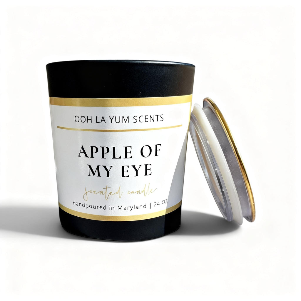 A Black Jar with a label 'Apple of My Eye' with a gold lid.