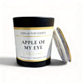 A Black Jar with a label 'Apple of My Eye' with a gold lid.